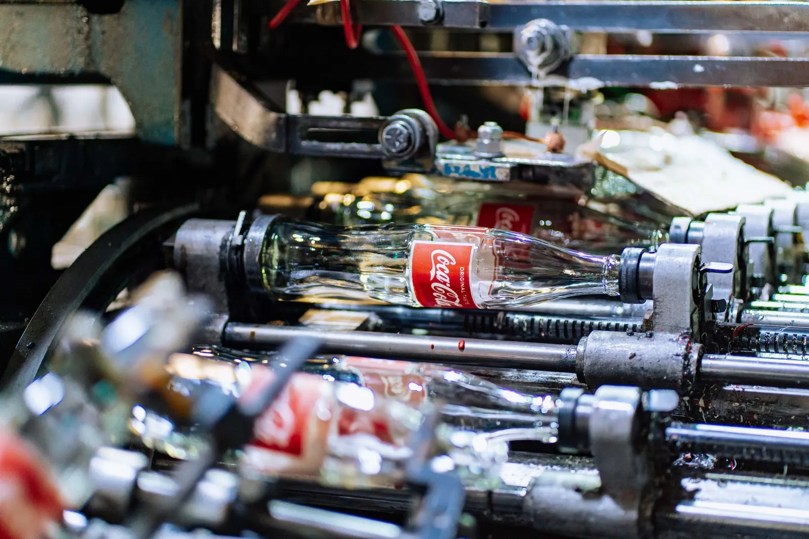 High-quality glass bottles being processed on a factory production line.